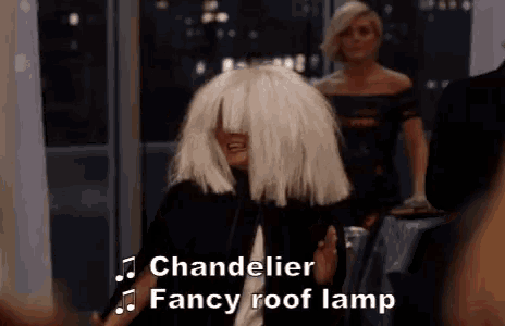 a woman in a white wig is singing a song .