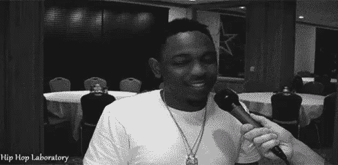 a black and white photo of a man talking into a microphone with hip hop laboratory written on the bottom