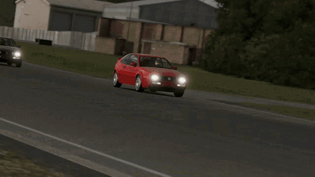 a red car is driving down a road in front of a building with a sign on the door that says ' house '