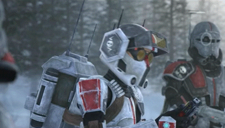 a group of soldiers are standing in the snow holding guns .