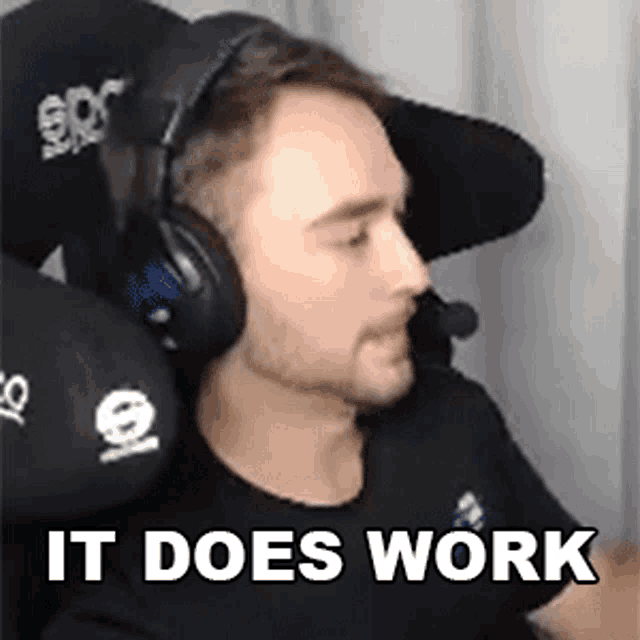 a man wearing headphones and a hat with the words `` it does work '' written on it .