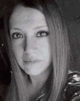 a black and white photo of a young woman with long hair