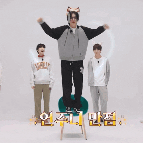 a man wearing a fox hat is standing on a chair next to two other people