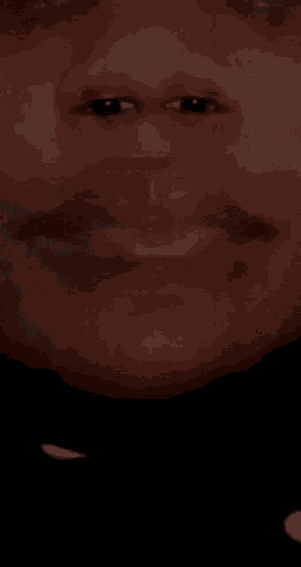 a close up of a man 's face with his mouth open