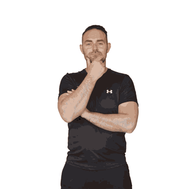 a man wearing an under armour shirt gives the thumbs up