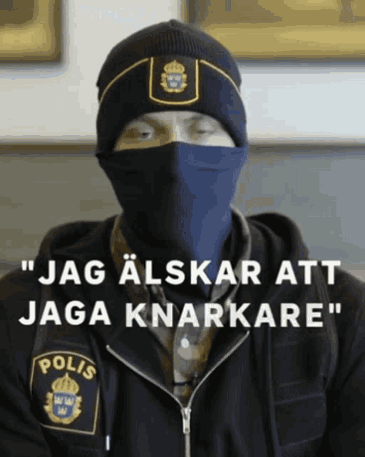 a man wearing a face mask and a jacket that says polis