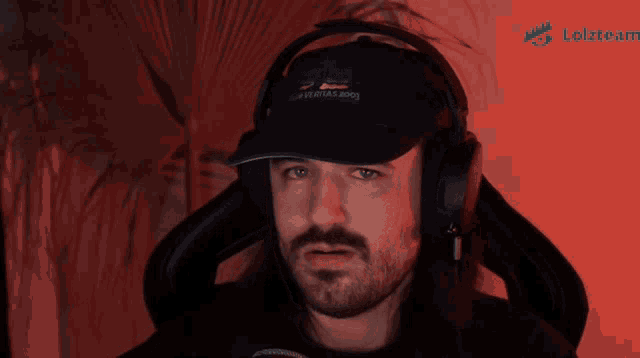 a man with a beard wearing headphones and a hat that says " kangaroos " on it