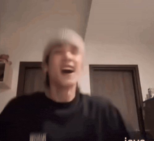 a blurry picture of a man wearing a beanie and a black shirt that says nirvana