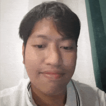a close up of a man 's face with a striped shirt on