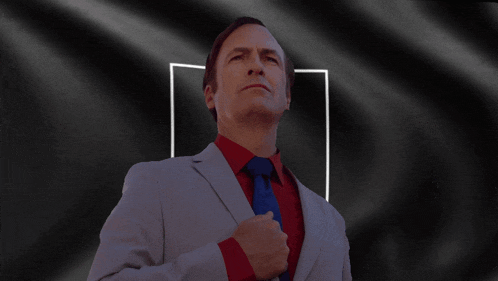 a man in a suit and tie looks up at the sky