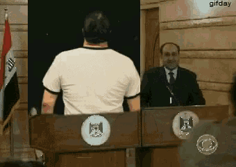 a man stands behind a podium that says gifday on the bottom