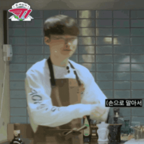 a man wearing an apron and a sweatshirt with the word aqua on the arm