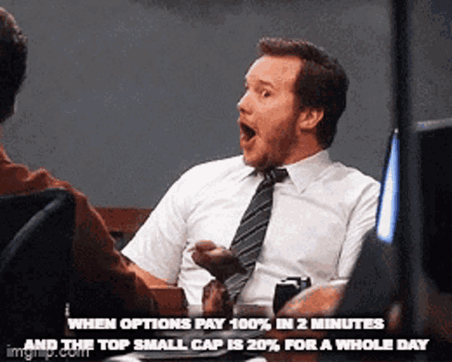 a man in a suit and tie is sitting at a desk