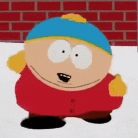 a cartoon character from south park is standing in the snow and smiling .