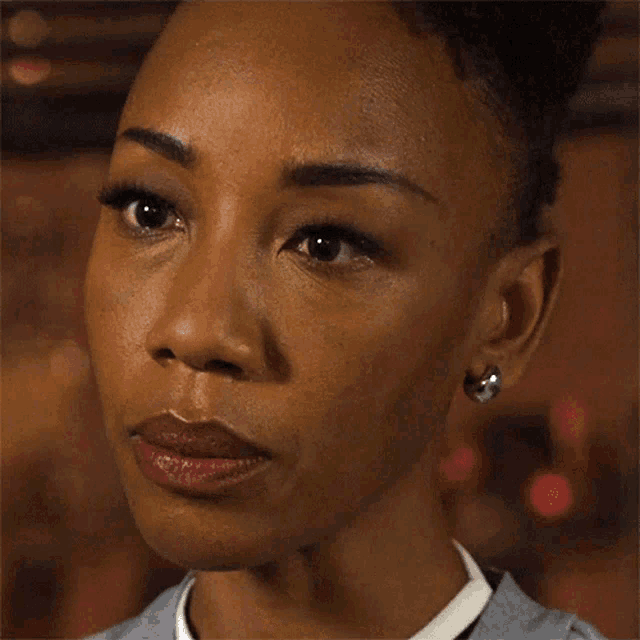a close up of a woman 's face with the words huh on her face