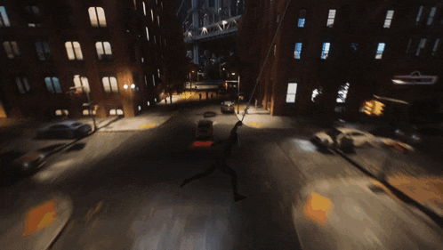 a person is hanging from a rope in the middle of a street
