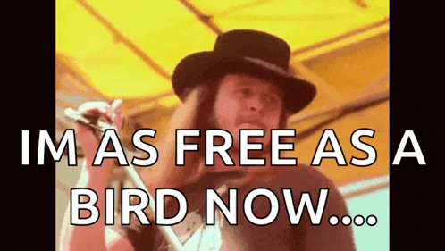 a man singing into a microphone with the words " im as free as a bird now "