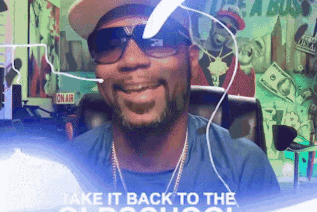 a man wearing sunglasses and a hat is smiling in front of a sign that says take it back to the old school