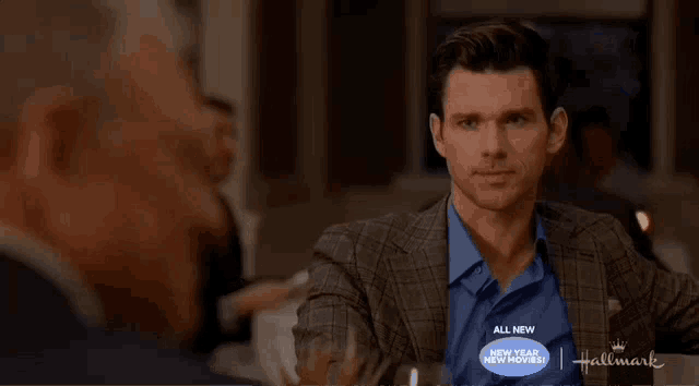 a man wearing a blue shirt that says all new new year new movies