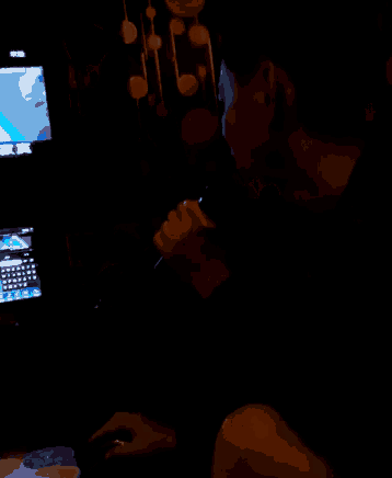 a man singing into a microphone in front of a screen that says ' karaoke '