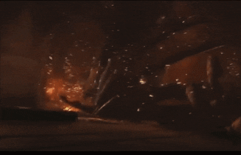 a large building is on fire with a lot of flames coming out of it