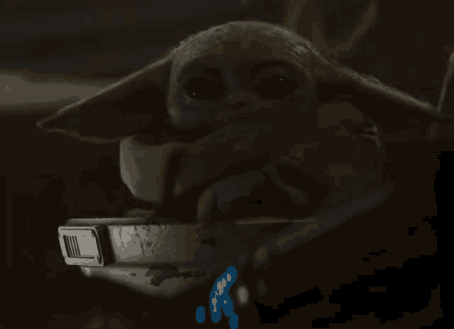 a close up of a futuristic helmet with a blue light coming out of it in a dark room .