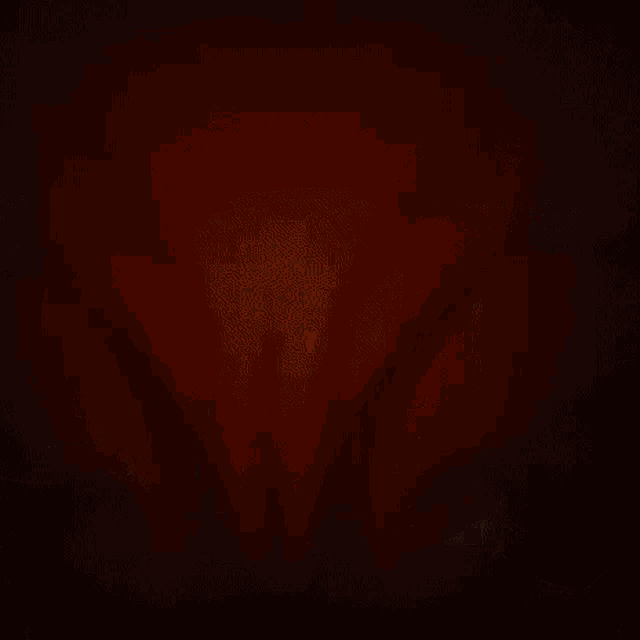a close up of a cartoon character 's face with a bloody mouth and fangs .