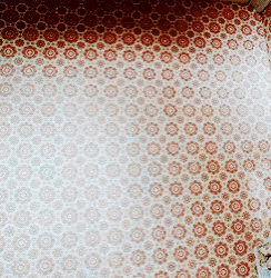 a wall with a pattern of red circles on a white background