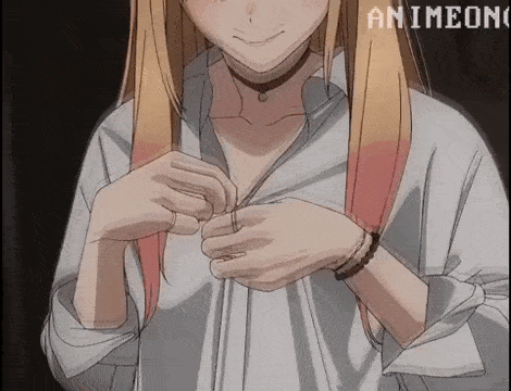 a girl with long blonde hair is taking off her shirt and revealing her breasts .