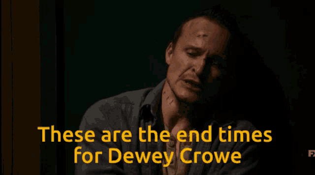 a man in a dark room with the words " these are the end times for dewey crowe " behind him