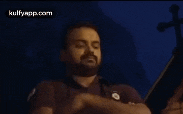 a man is covering his nose with his hand while playing a violin .