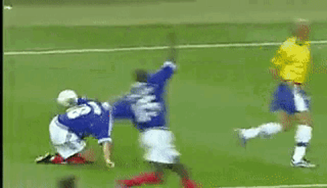 a soccer player wearing a number 18 jersey jumps in the air