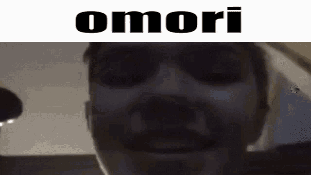 a close up of a man 's face with the word omori written above him .