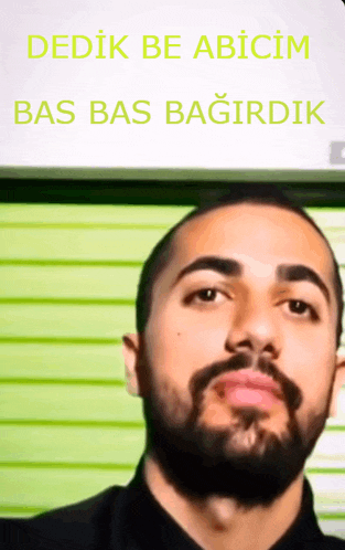 a man with a beard looks at the camera with the words dedik be abicim bas bas bagirdik below him