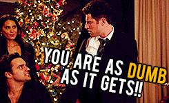 a group of people are standing in front of a christmas tree with a caption that says you are as dumb as it gets
