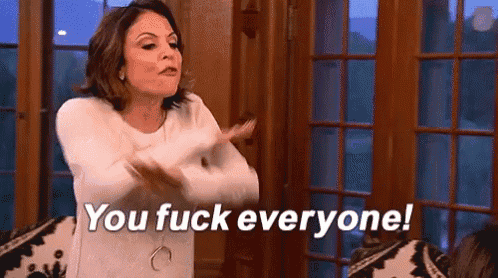 a woman is standing in front of a window with her arms outstretched and says `` you fuck everyone '' .