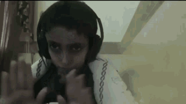 a person wearing headphones and a shirt that says kappa