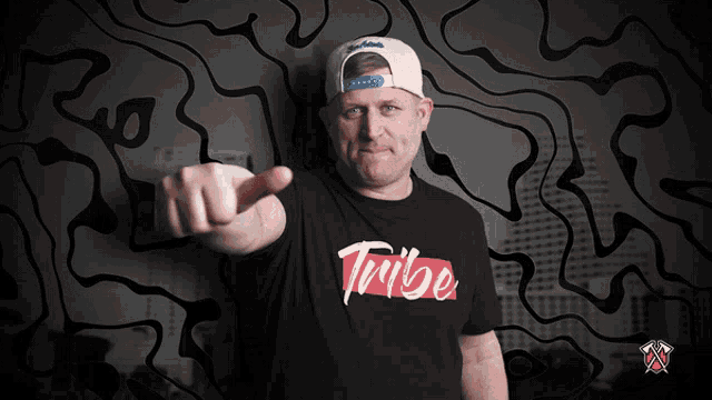 a man wearing a t-shirt that says " trille " is pointing his finger