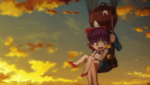 a boy and a girl are sitting on a swing in the air