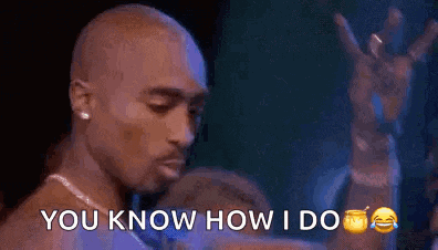 a man is standing in front of a microphone with the words `` you know how i do '' written on it .