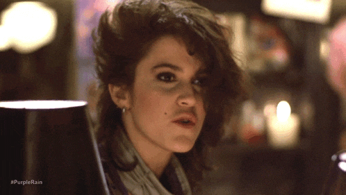 a close up of a woman 's face with the hashtag #purplerain above her
