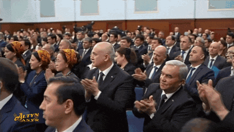 a large group of people are sitting in a room with the word altyn on the bottom