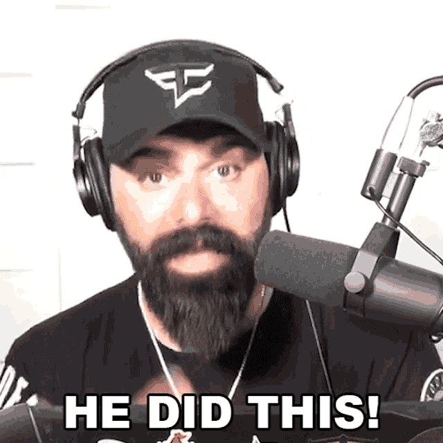 a man with a beard is wearing headphones and a hat and says he did this
