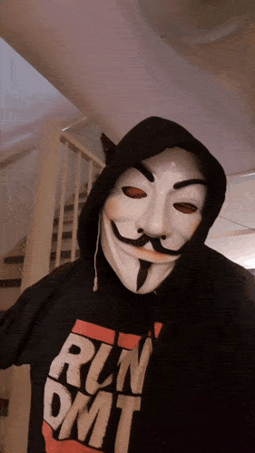 a person wearing a mask and a run dmt hoodie