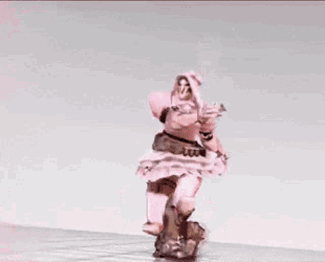 a woman in a pink dress and armor is dancing in the snow .