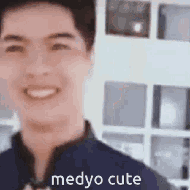 a close up of a man 's face with the words medyo cute .
