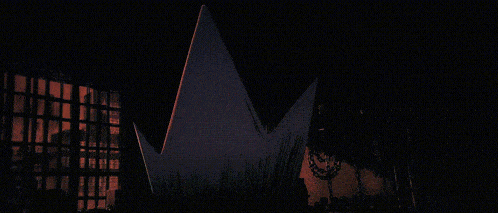 a black background with a bunch of brush strokes and a cross