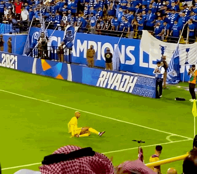 a soccer field with a sign that says riyadh
