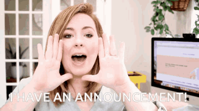 a woman is holding her hands up in front of her face and says i have an announcement