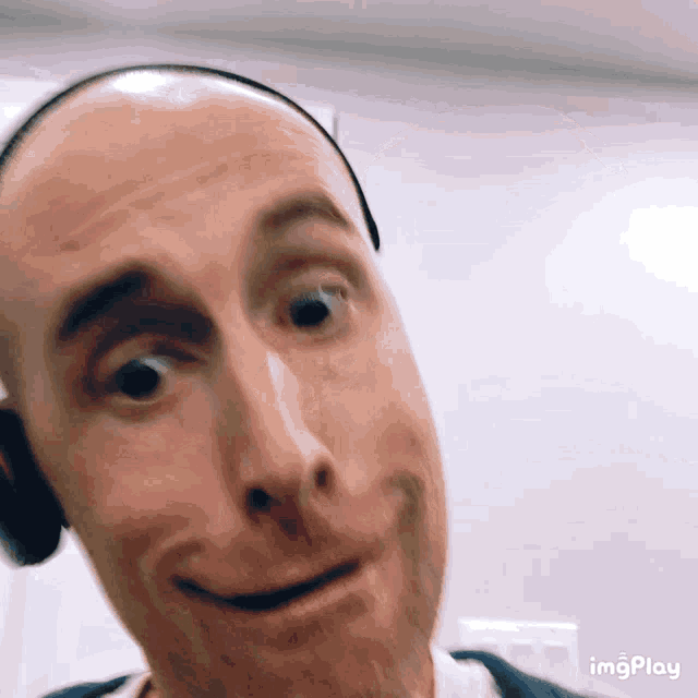 a close up of a man 's face with the words imgplay visible in the corner